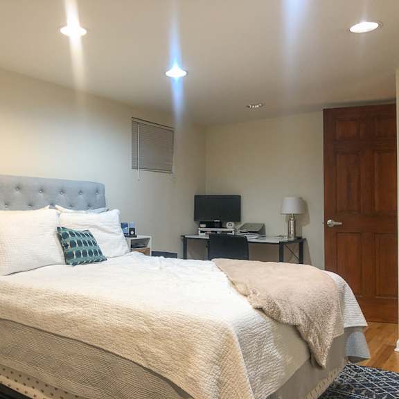 a bedroom with a large bed and a television in the corner.