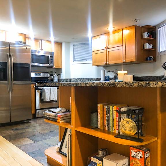 a kitchen with a refrigerator, microwave, and oven.