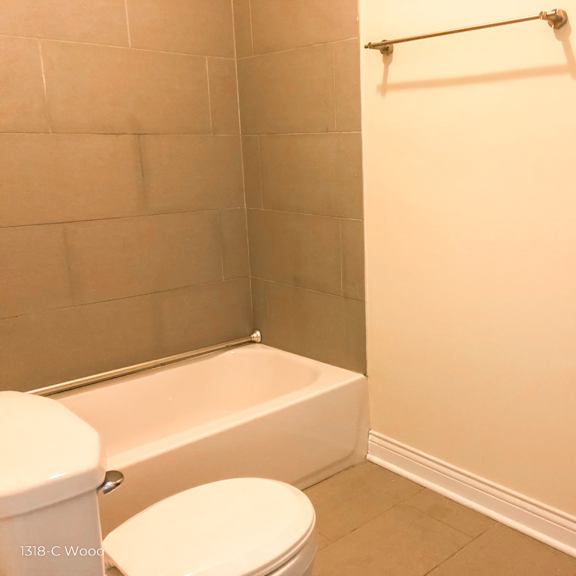 a small bathroom with a toilet and a bath tub