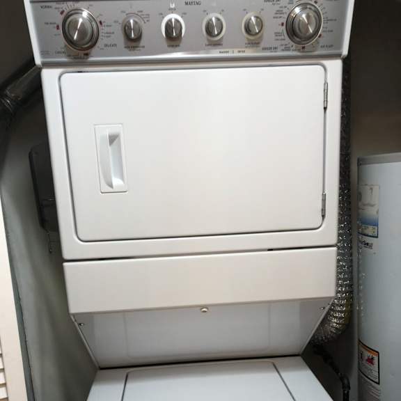 a white stove top oven sitting next to a washer and dryer