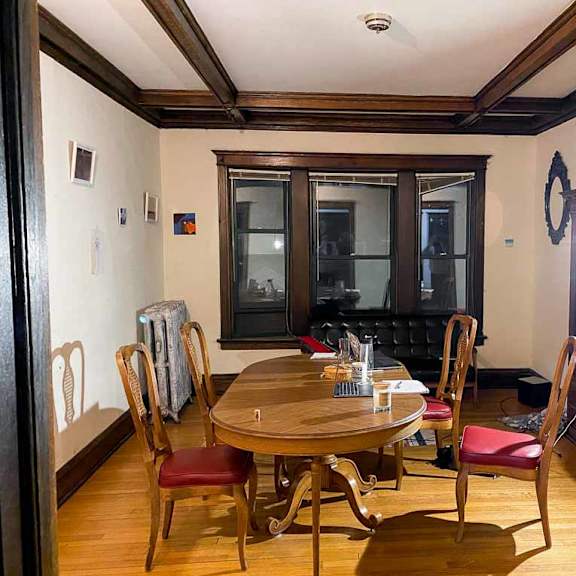 a dining room with a wooden table and chairs.