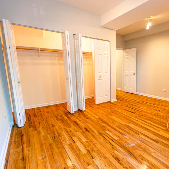 a room with wooden floors and white walls.