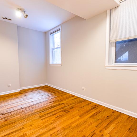 a room with wooden flooring and a window.
