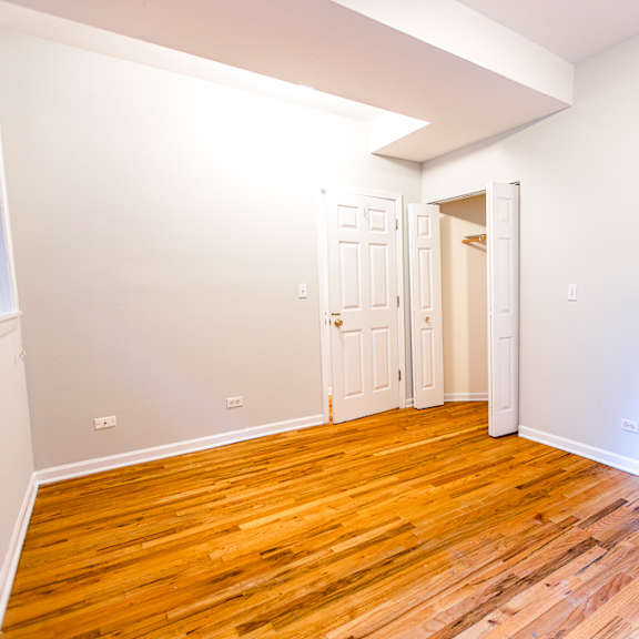 a room with wooden floors and white walls.