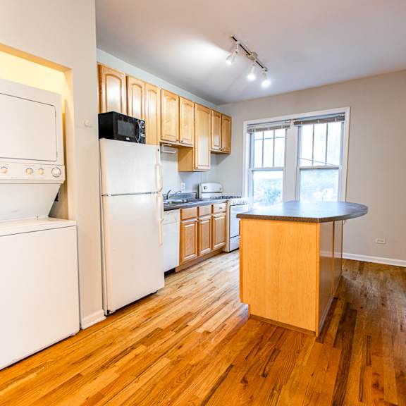 a kitchen with a white fridge and a white oven.