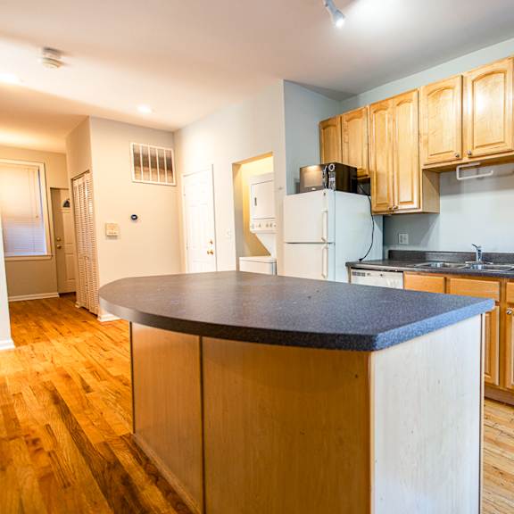 a kitchen with wooden cabinets and a white stove.