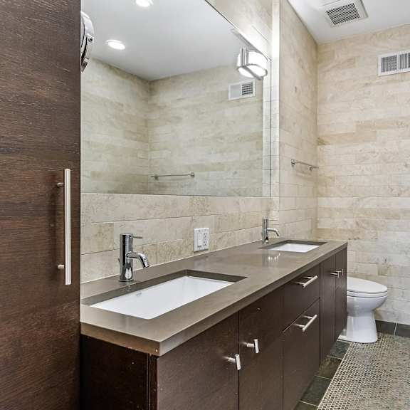 a bathroom with a toilet, sink, and bathtub.