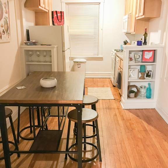 a kitchen with a table and chairs in the middle of the room.