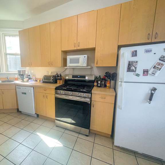 a kitchen with wooden cabinets and a white refrigerator.