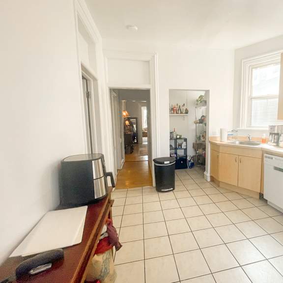 a kitchen with white appliances and wooden cabinets.