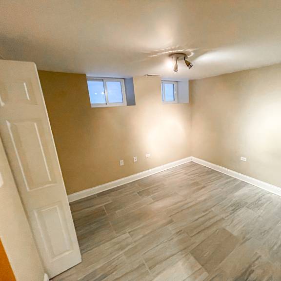 a room with wooden flooring and a ceiling fan.