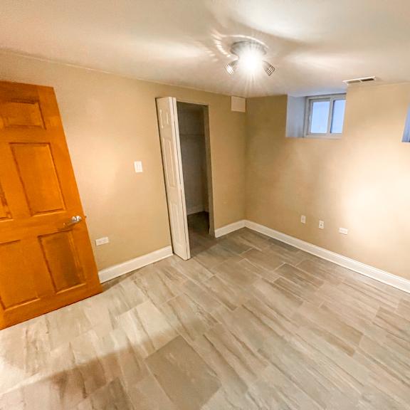 a room with a wooden door and a window with a white frame.