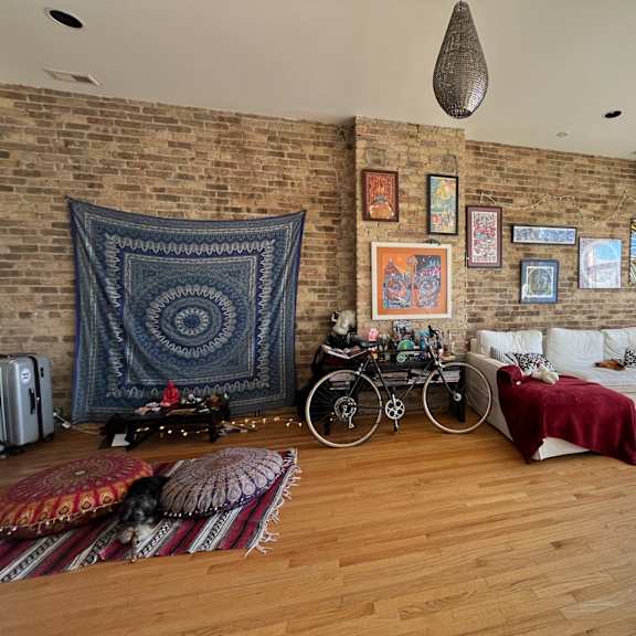 a living room with a brick wall and a bicycle.