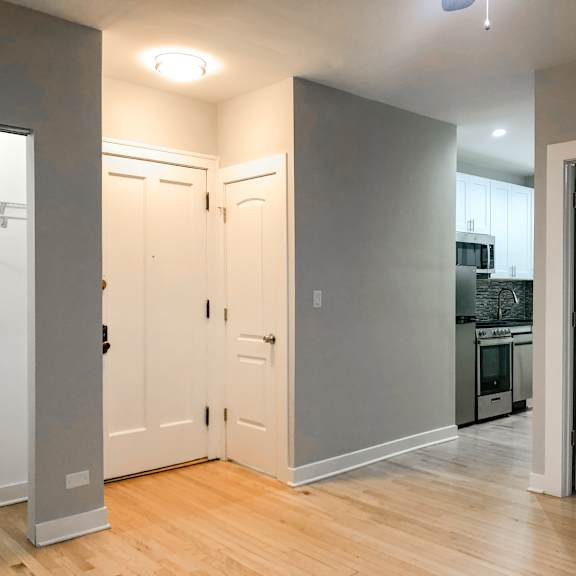 a kitchen area with a refrigerator, oven, and sink.