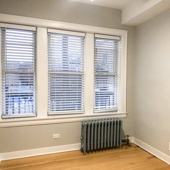 a room with a window and a radiator on the floor.