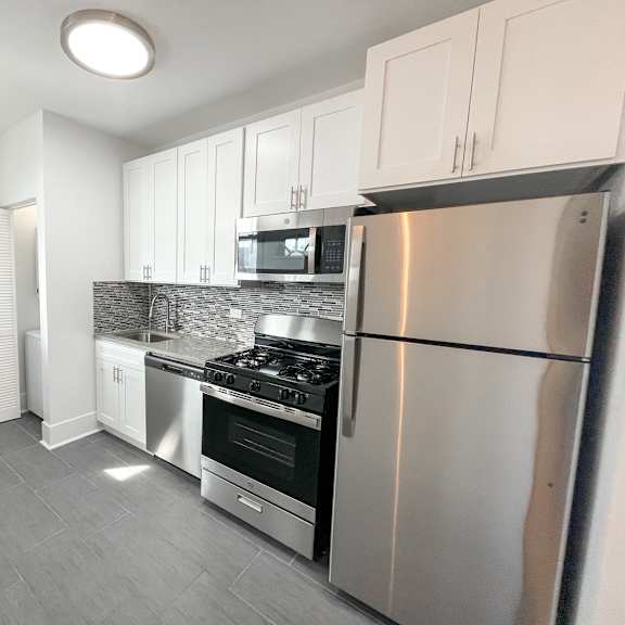 a kitchen with a stove, oven, and refrigerator.