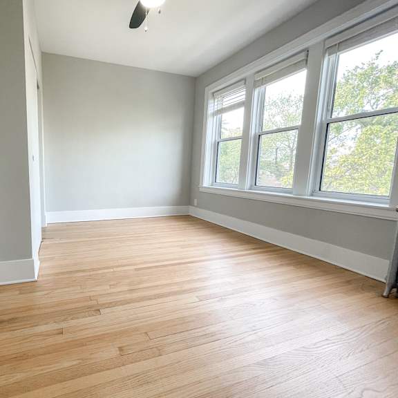 a room with wooden flooring and a window.
