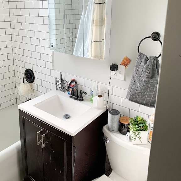 a bathroom with a white sink and a white tub.