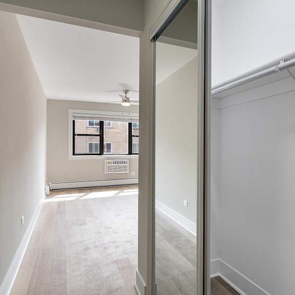 a bedroom with a medium sized closet and a ceiling fan