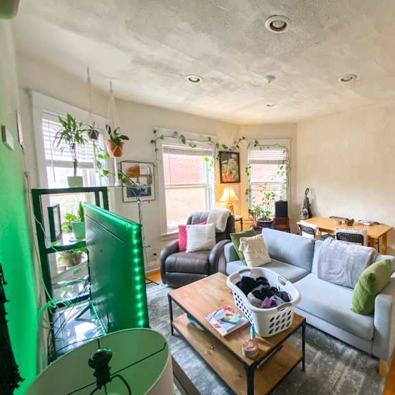 a living room with a grey couch and a wooden coffee table.