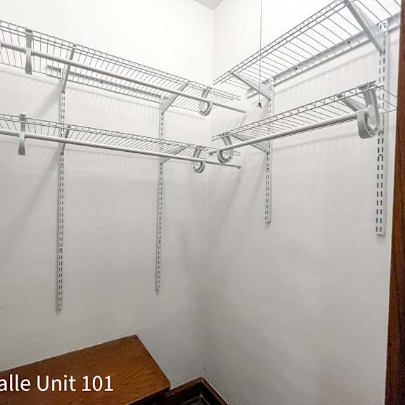 a white wall with a metal rack hanging from it.