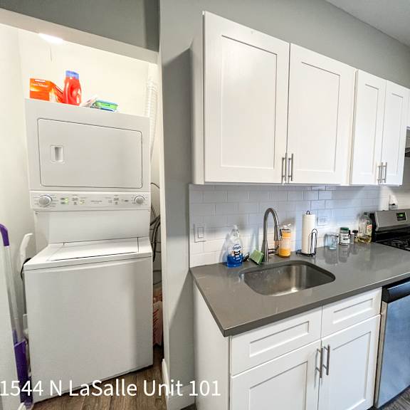 a kitchen with white cabinets and a white fridge.