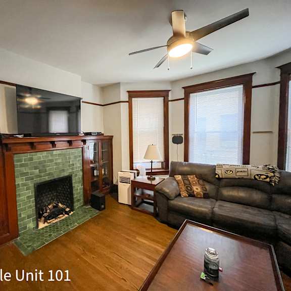 a living room with a fireplace and a couch.