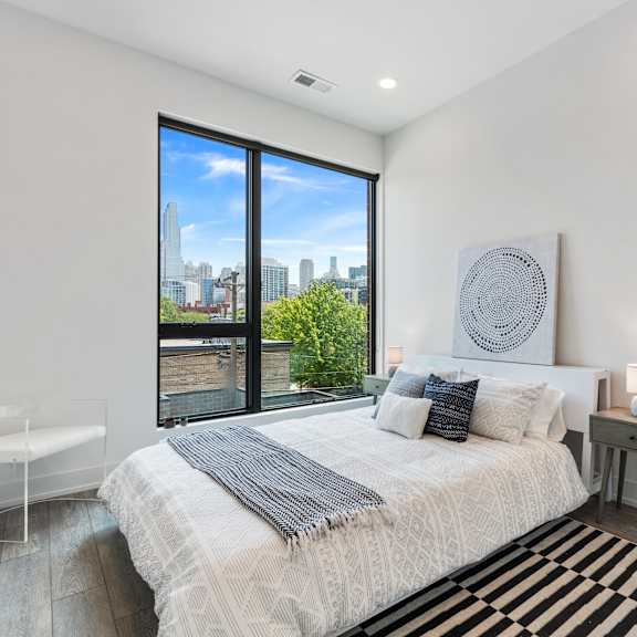 a bedroom with a large bed and a large window