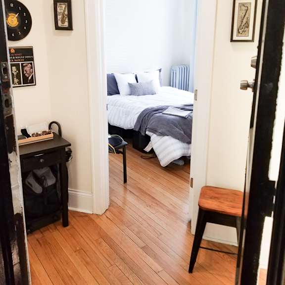 a bedroom with a bed, a desk, and a chair.