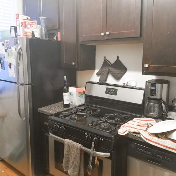 a kitchen with a black stove top oven and a black refrigerator.