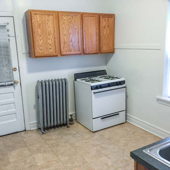 a white stove and oven in a kitchen with wooden cabinets.