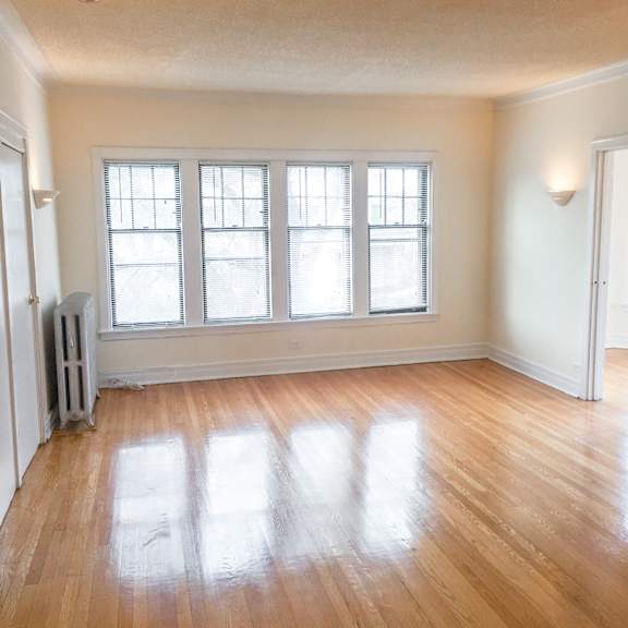 a room with a wooden floor and a window.