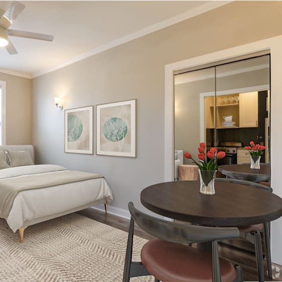 a bedroom with a bed and a living room with a couch and a table