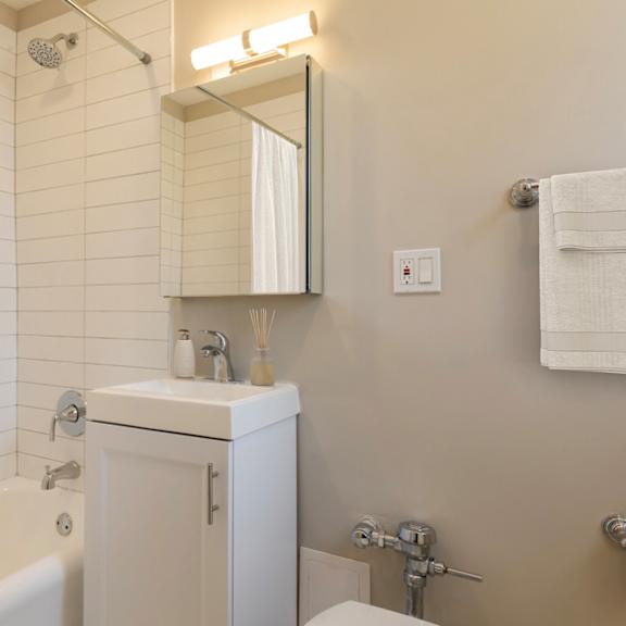 a small bathroom with a sink and a bath tub