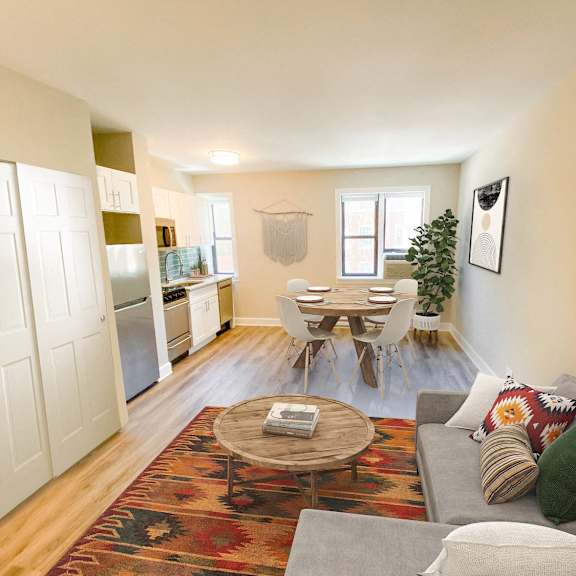 a living room with a couch and a table and a kitchen