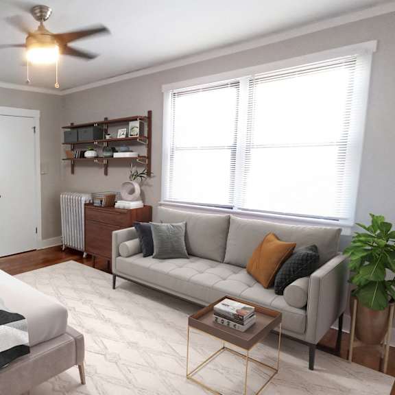 a living room with a grey couch and a coffee table.