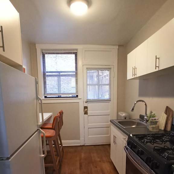 a kitchen with a stove and a refrigerator.
