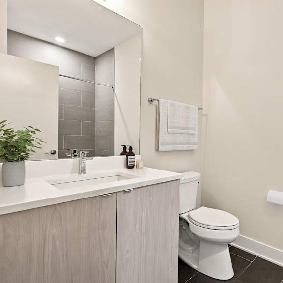 a white toilet sits in a bathroom next to a sink.