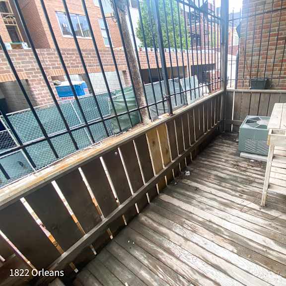 a wooden deck with a table and chairs on it.
