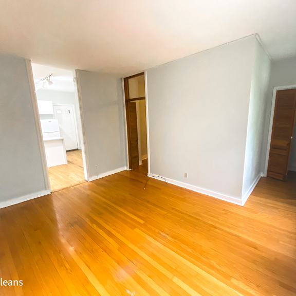 a room with wooden floors and white walls.