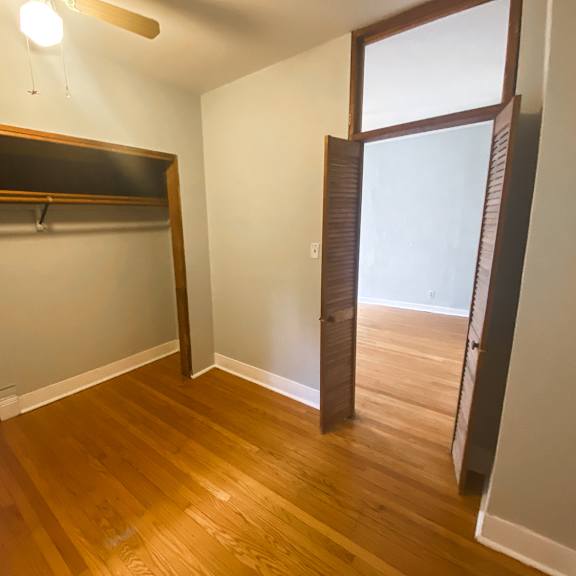 a room with a wooden floor and a large window.