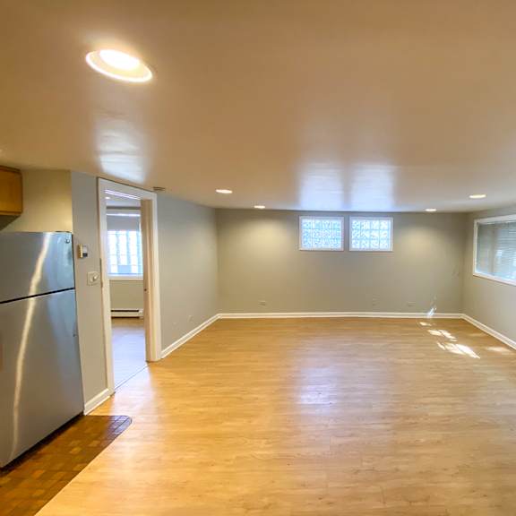 a kitchen with a refrigerator and a window.
