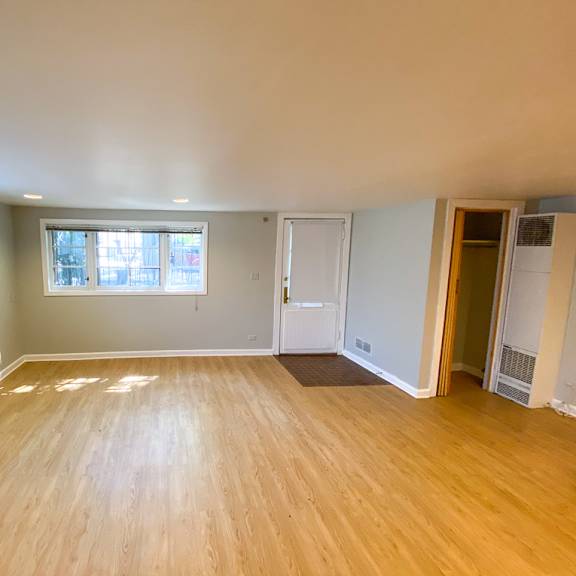 a room with wooden flooring and a window.