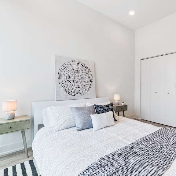 a bedroom with a bed and two night stands