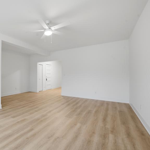 a room with wooden flooring and a ceiling fan.