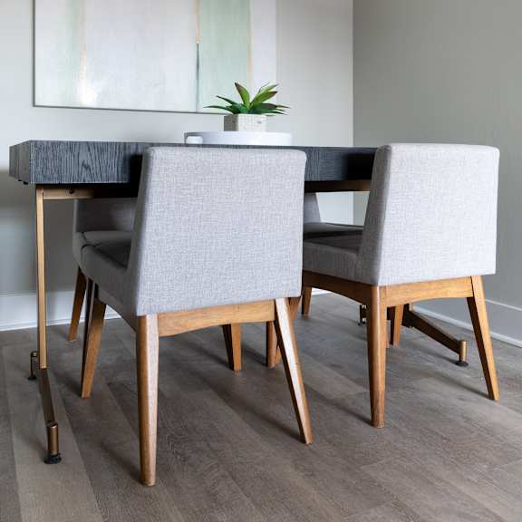 a dining room with a table and chairs