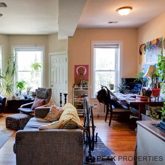 a living room filled with furniture and a dining room table