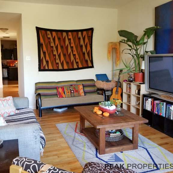 a living room filled with furniture and a tv