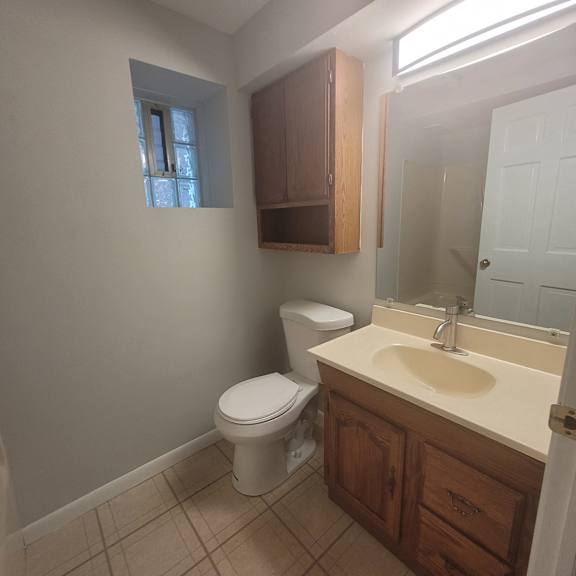 an empty bathroom with a toilet and a sink