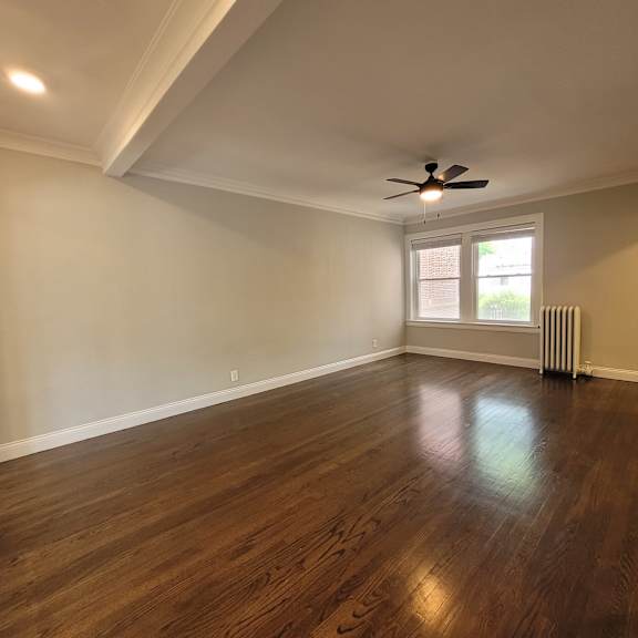 a room with a ceiling fan and a window.